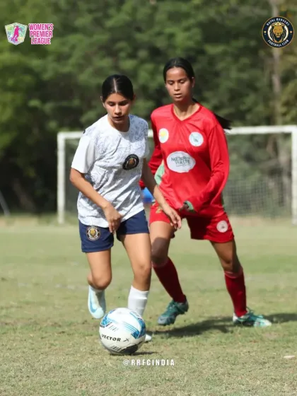 A moment of intense competition as our player holds off a defender to maintain control of the ball.