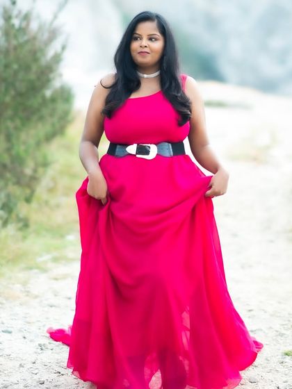 A solo shot of the bride-to-be, looking confident and beautiful. The makeup is soft and natural, letting her personality shine through.