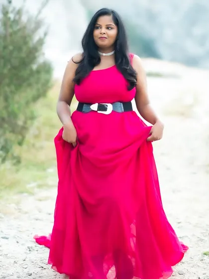 A solo shot of the bride-to-be, looking confident and beautiful. The makeup is soft and natural, letting her personality shine through.