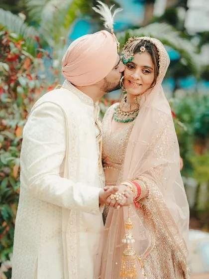 A sweet and affectionate kiss on the cheek. We capture these candid moments of love that happen naturally during a couple's portrait session.