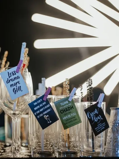 Quirky and fun drink tags at the Sangeet bar, with phrases like "Less drama more gin," adding a touch of humor and personality.