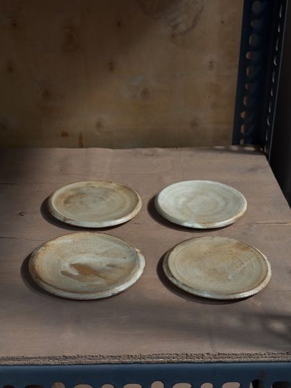 A set of four handmade plates, versatile enough to be used for cookies, desserts, or as coasters. These were thrown and glazed by our studio team, making each one a collaborative effort.