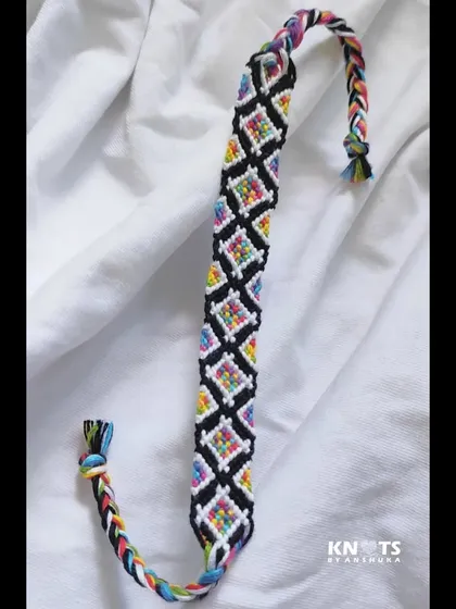 Another look at the rainbow diamond bracelet, showcasing its full length and colorful braided ends.