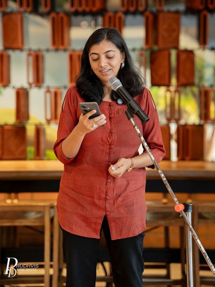A performer reads from her phone, her expression reflecting the depth of her poem. Our "Love Without Labels" event was a mosaic of personal truths.
