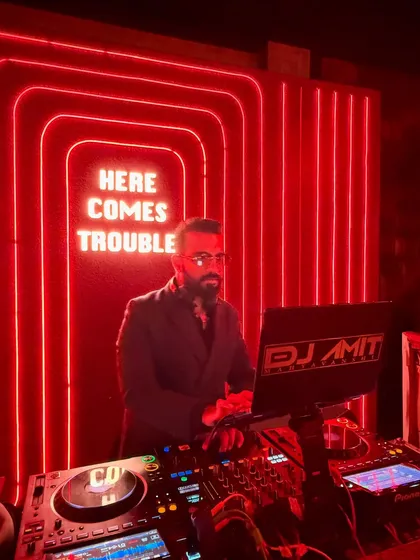 Another angle of me at the decks under the "HERE COMES TROUBLE" sign. The red neon creates a powerful mood.