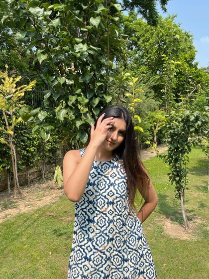 A happy, smiling shot surrounded by greenery.