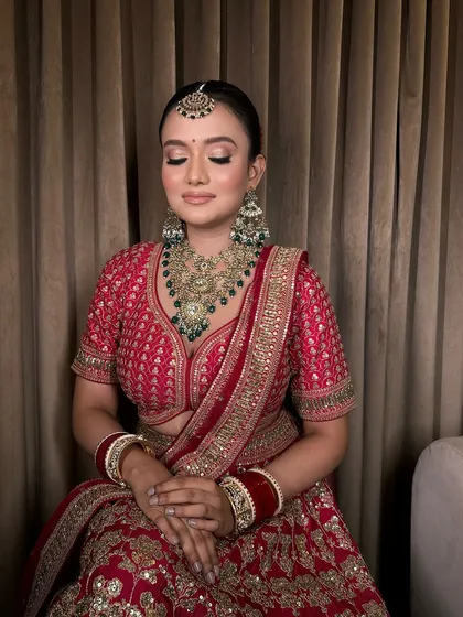A close-up of this bride's serene look. The heavy, antique-finish necklace with green stones is the star of her ensemble.