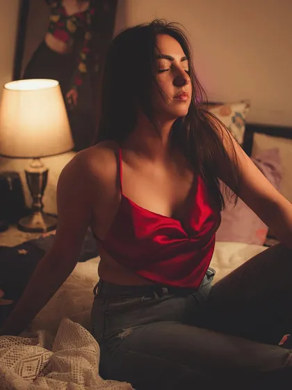 A relaxed, moody shot in a bedroom setting, creating an intimate and personal feel.