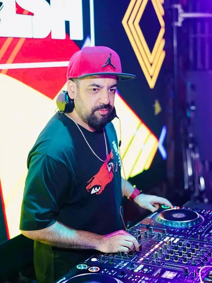 On the decks at Happy Brew, with my name lit up on the big screen behind me. Ready to drop some Desi HipHop and UK Bhangra.