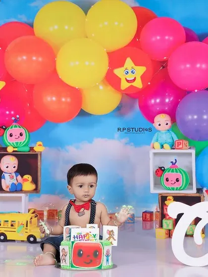 I love creating shoots based on popular characters, like this vibrant Cocomelon-themed first birthday. The colorful balloon arch and familiar toys create a fun and engaging environment for your child to enjoy their cake smash.