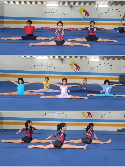 Our gymnasts practicing their middle splits in perfect synchronization. This level of flexibility is essential for both artistic and aerobic gymnastics.