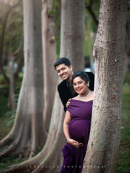 A playful peek-a-boo pose from behind a tree adds a touch of fun and spontaneity to the session.