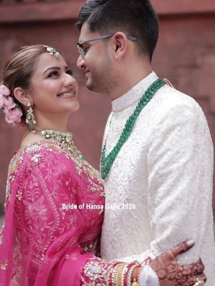A romantic portrait of the couple. The bride's mehendi is visible as she embraces the groom, a beautiful detail in this intimate and loving shot.