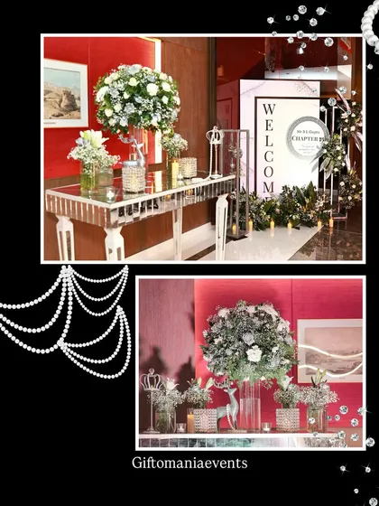 A look at the entrance and accent decor for the silver glam 75th birthday. This includes a mirrored console table with large white floral arrangements and a personalized welcome sign, setting a luxurious tone from the moment guests arrive.