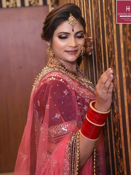 Another angle of the beautiful bridal look, focusing on the detailed makeup and jewelry.