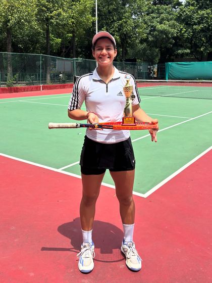 Posing with a well-earned trophy. Riya's back-to-back national titles are a testament to her relentless dedication.