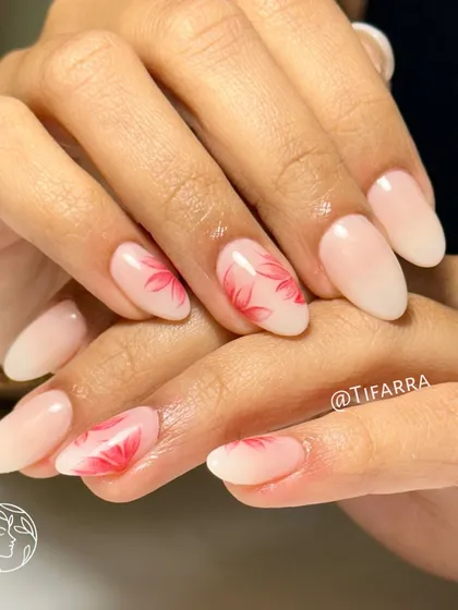 Blooming beauty at your fingertips. Gel extensions with a soft ombre base and hand-painted red floral art.