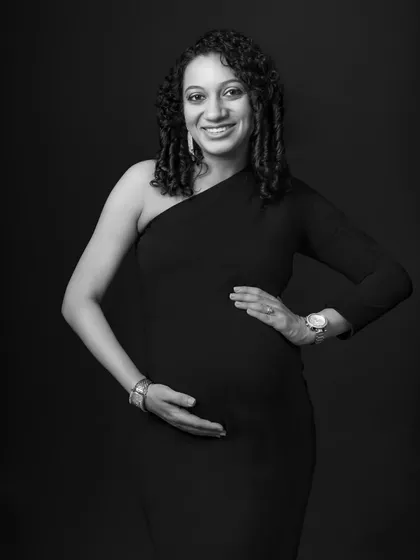 A confident and elegant pose in a classic one-shoulder dress. The black and white treatment adds a layer of sophistication and timelessness.