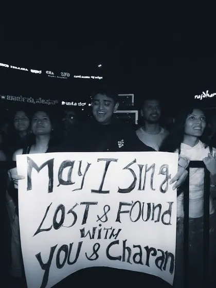 A dedicated fan holds up a sign, hoping for a special moment with the artist. I strive to create an atmosphere where fans feel connected and part of the show.