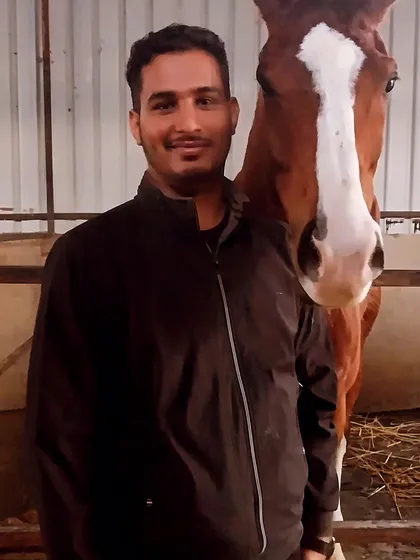 A member of our team posing with Vikrant, one of our favorite horses. This shows the close bond we have with our animals.
