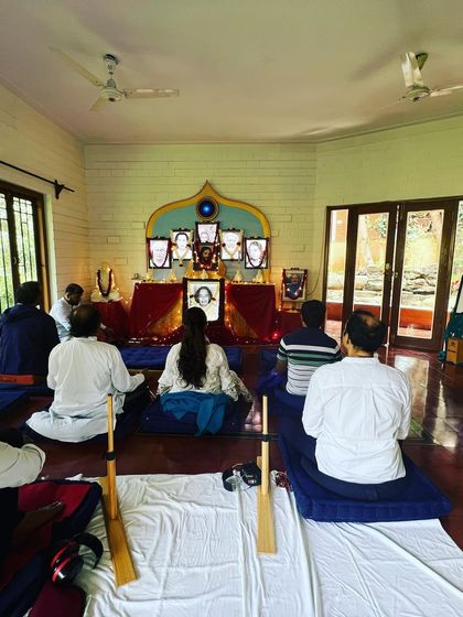 Another view of our Christmas meditation, showing the group from behind as they face the beautifully decorated altar. The use of meditation benches and cushions ensures comfort during longer periods of silent sitting.