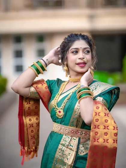 This pose highlights the shoulder pleats and the way the saree is secured. It's these small details that make a big difference in the overall finish of the drape.