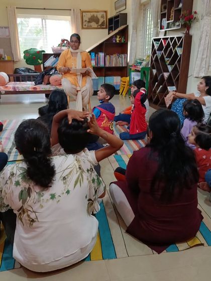 A storyteller reads an adventure story, her animated voice filling the room with excitement.