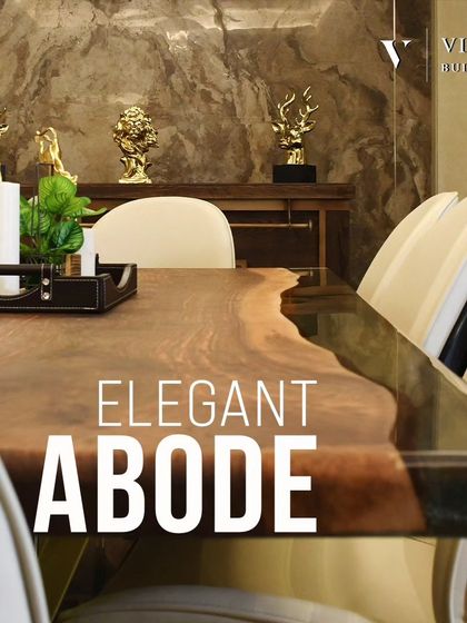An elegant abode for fine dining. The live edge wooden dining table is paired with modern chairs and accented with gold decor, all set against a dramatic, textured marble wall.