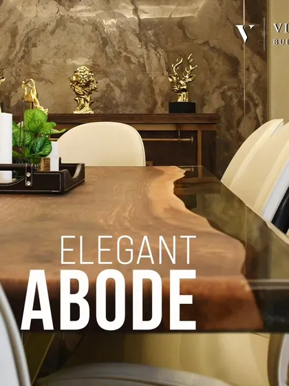 An elegant abode for fine dining. The live edge wooden dining table is paired with modern chairs and accented with gold decor, all set against a dramatic, textured marble wall.