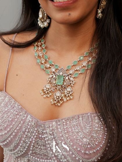 This Victorian neckpiece, paired with matching earrings, is a beautiful example of how traditional craftsmanship can be adapted for a modern aesthetic. The soft color palette makes it incredibly versatile.