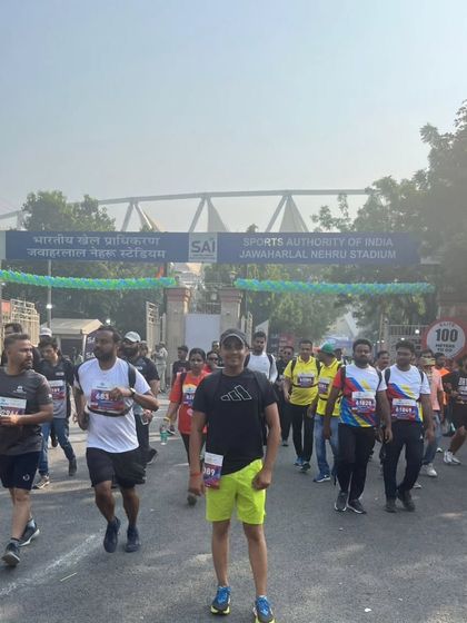 Running towards the entrance of Jawaharlal Nehru Stadium. The energy of a marathon day is unmatched. I train my students to be ready for this level of competition.
