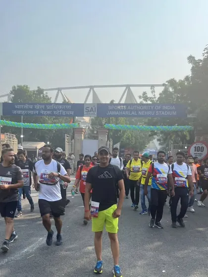 Running towards the entrance of Jawaharlal Nehru Stadium. The energy of a marathon day is unmatched. I train my students to be ready for this level of competition.