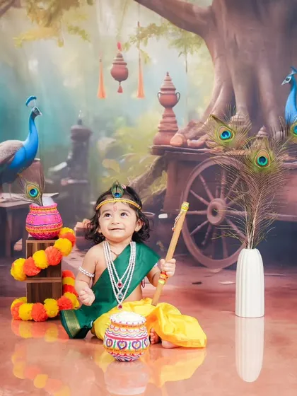 Looking up towards the heavens, this little Krishna pose is full of wonder. The detailed background and props help build a complete story within the photograph.