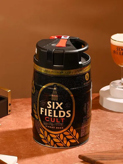 A bar-top scene styled for a Six Fields Cult wheat beer keg. I used warm tones and bar accessories to create a cozy, pub-like atmosphere, making the at-home keg feel like a special occasion.