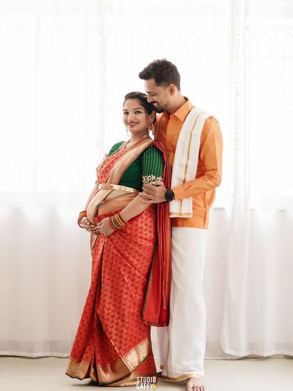 A classic portrait of the couple in traditional South Indian attire, standing proudly together.