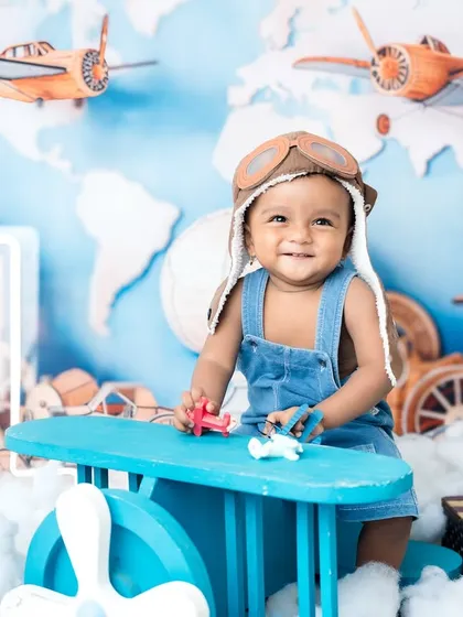 Another angle of our happy little pilot, ready to explore the world in his first birthday photoshoot.