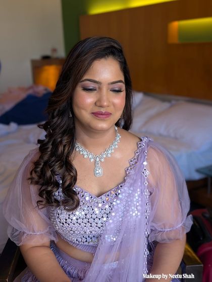 A close-up of the soft purple eyeshadow and radiant skin. This look proves that you don't need a filter when the makeup is skillfully applied.