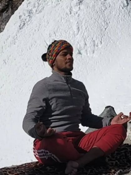 YogGuru Chandra Mohan in meditation amidst the snow-capped mountains, embodying the deep spiritual roots of our yoga practice.