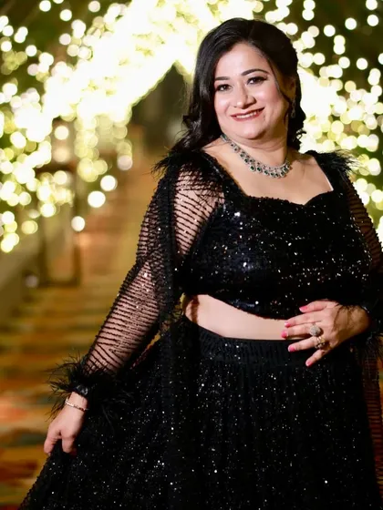 A glamorous party look in a black designer outfit. The makeup is sophisticated and perfect for a special occasion.