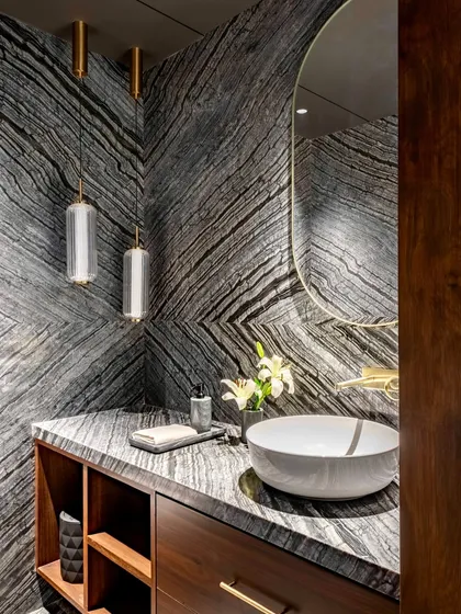 Materiality is at the core of our practice. In this powder room for the Parishram residence, we used book-matched slabs of dramatic, locally sourced granite to create a powerful visual statement, turning a functional space into a work of art.