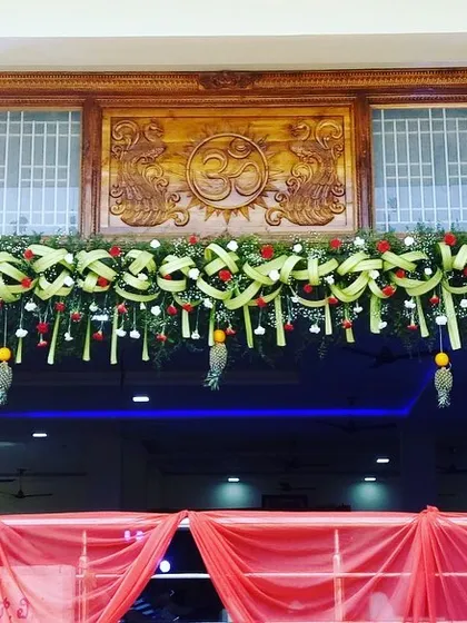 A wedding entrance should be a beautiful welcome for your guests. Here, I used traditional elements like woven coconut leaves, marigolds, and roses to create a festive and culturally rich entryway for a South Indian wedding.