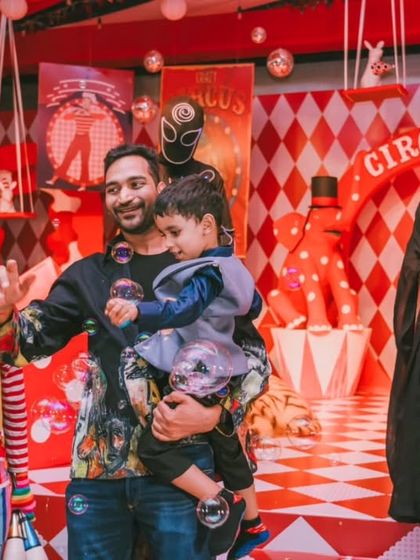 The birthday boy and his family interacting with a friendly clown and LED robots. I ensure the entertainment is engaging and family-friendly, creating happy memories for everyone.