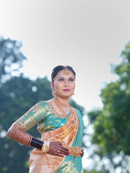 Arpitha looking powerful and poised in her teal and gold saree, ready for her muhurtham.