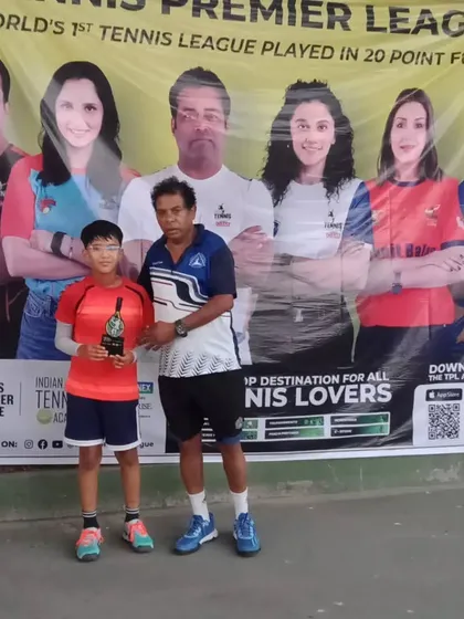 A junior player receives his winner's trophy at the conclusion of the TPL-ITA tennis tournament. Our staff ensures a smooth and memorable awards ceremony for all winners and finalists.