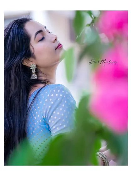 Using my 85mm prime lens, I created this soft, dreamy portrait. The foreground flowers add a beautiful layer of depth and color, framing her peaceful expression. This style is perfect for capturing a gentle, artistic vibe.