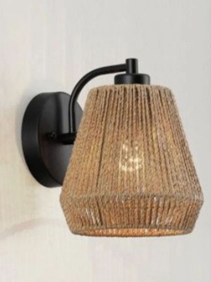 Our jute-wrapped wall sconce features a simple, conical shade on a black metal fixture. The natural texture of the jute rope adds a rustic, coastal feel, perfect for adding warmth to a bedroom or hallway.