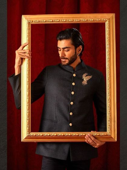 A creative shot of our dark bandhgala, framed to highlight its artistic quality. This isn't just a jacket; it's a piece of wearable art.