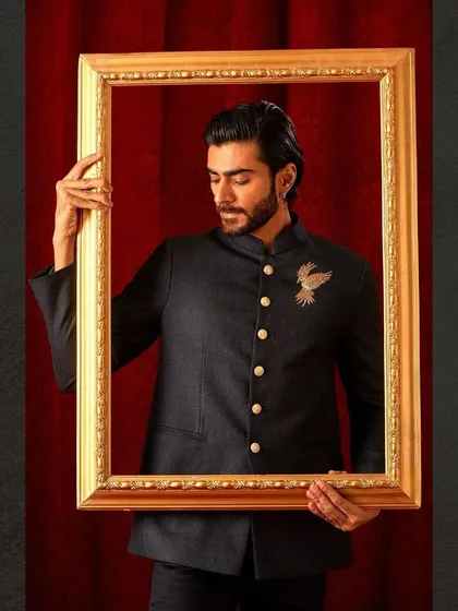 A creative shot of our dark bandhgala, framed to highlight its artistic quality. This isn't just a jacket; it's a piece of wearable art.