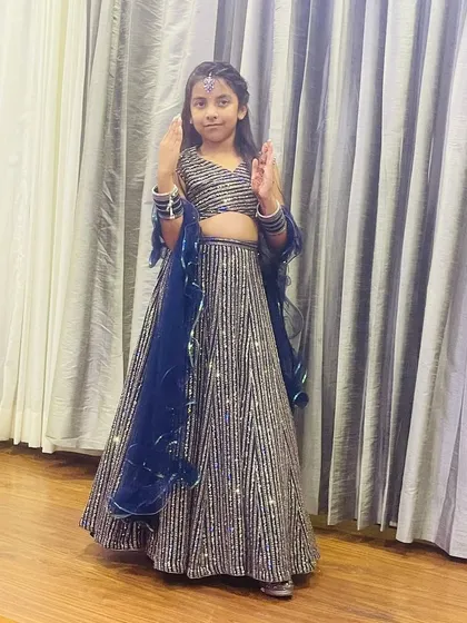 A happy little client in a sparkling navy blue and silver sequin lehenga. This custom outfit is perfect for a reception or evening party.
