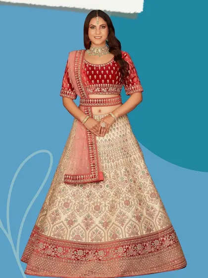 A beautiful two-tone bridal lehenga combining a cream skirt with a rich red velvet blouse. This outfit offers a unique take on traditional bridal colors.